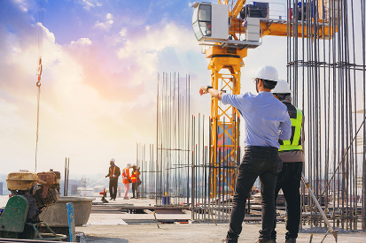 two individuals looking out at a worksite